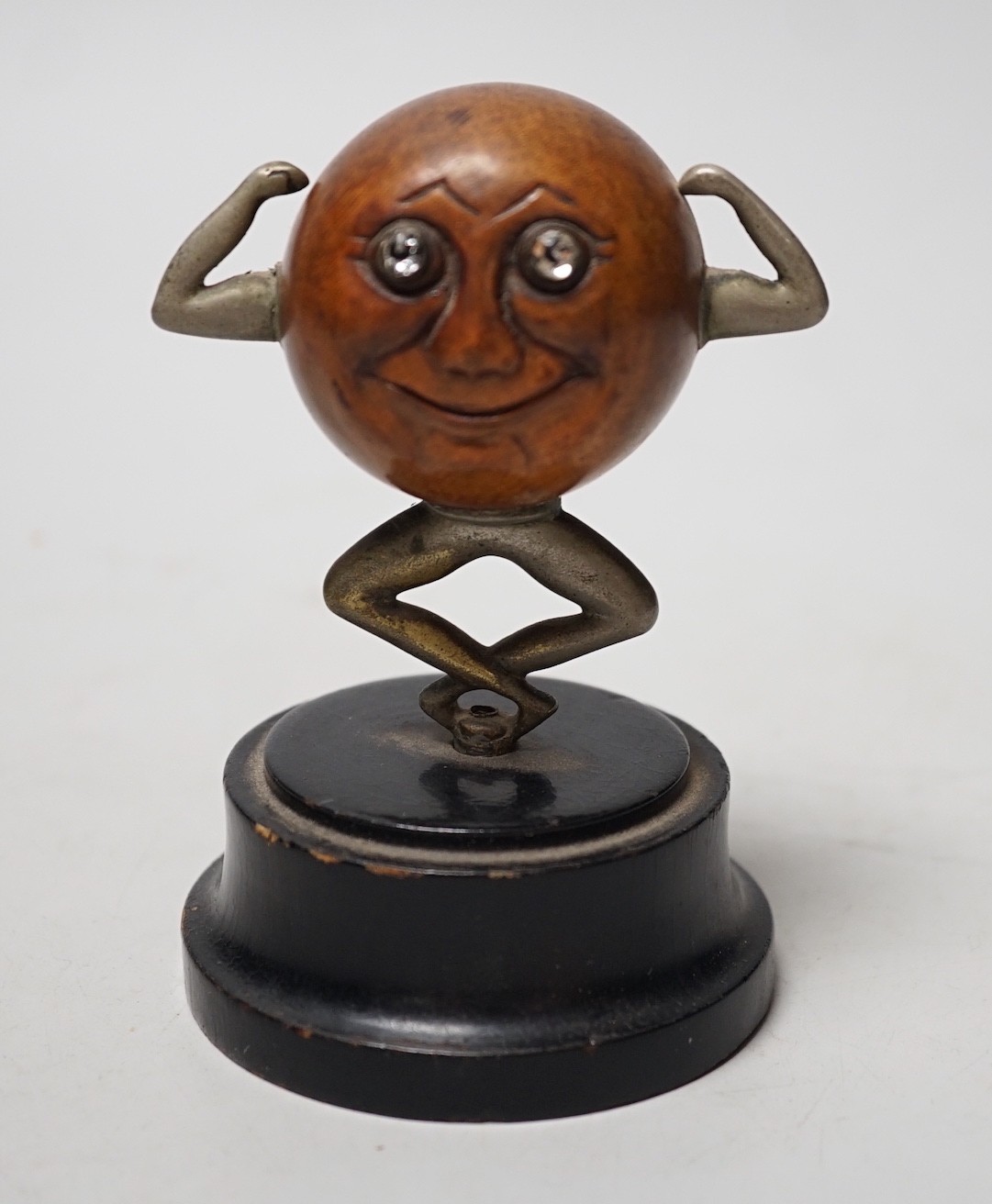 An early 20th century 'Touch Wud' figure, on an ebonised plinth 11cm tall